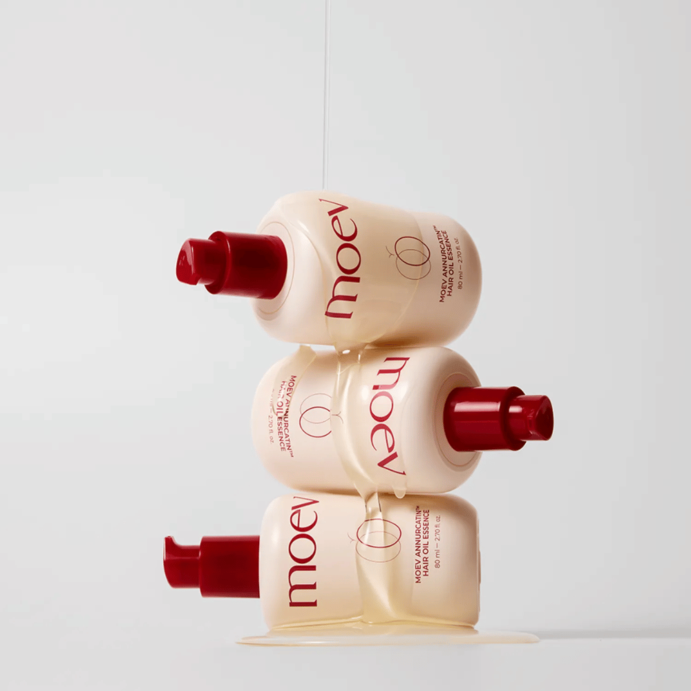 Three bottles MOEV Annurcatin Hair Oil Essence stacked – nutritious hair oil with Annurca apple and biotin that strengthens, protects, and gives hair shine and elasticity.