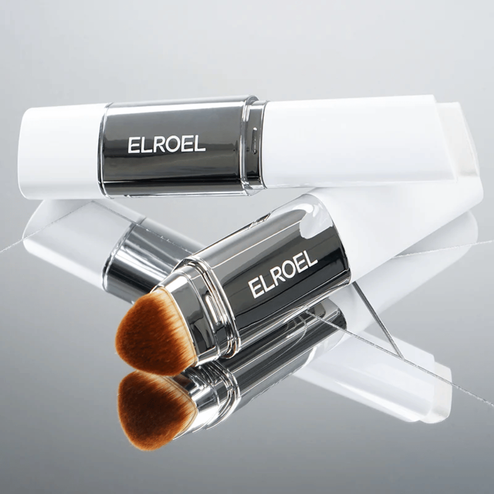 ELROEL Blanc Cover Cream Stick with an integrated brush placed on a mirror surface to show soft bristles and even application.