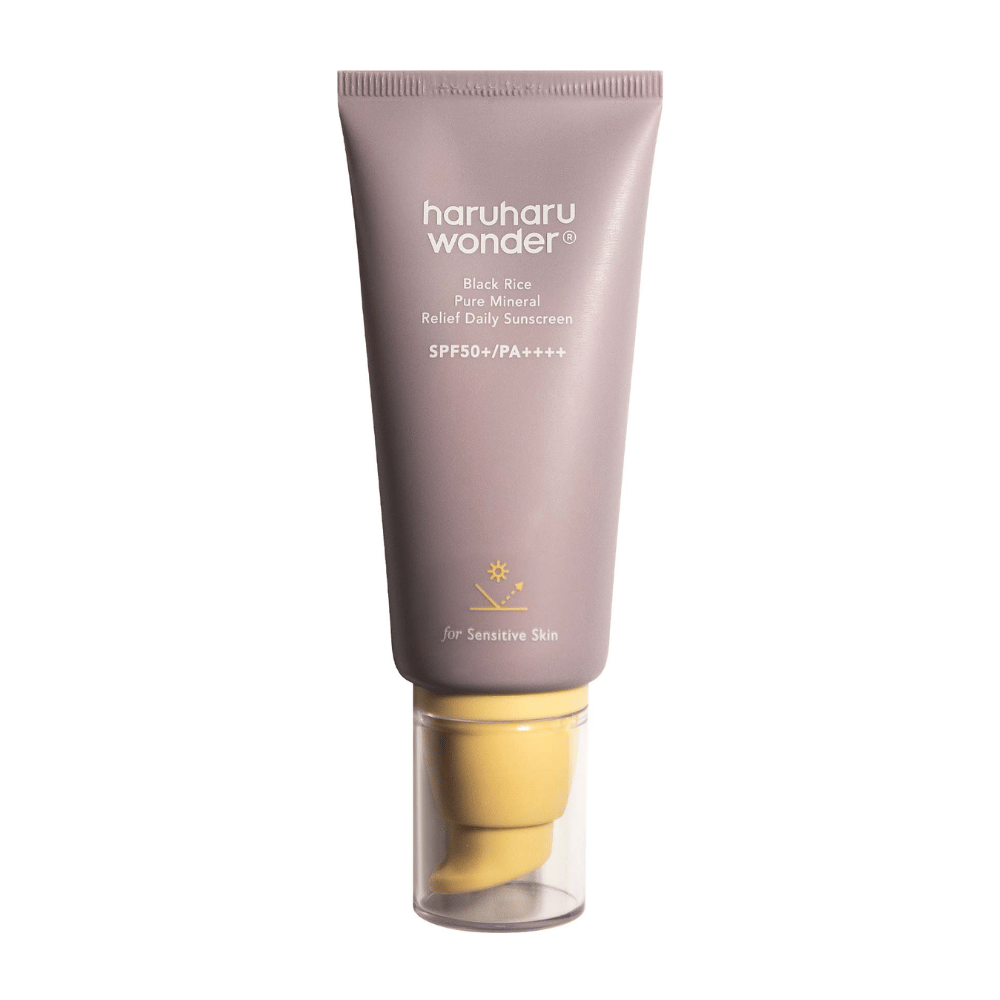 A purple tube with Haruharu Wonder Black Rice Pure Mineral Relief Daily Sunscreen SPF 50+ PA++++. The tube has a transparent cap and text describing the sunscreen's high level of protection, specially adapted for sensitive skin.