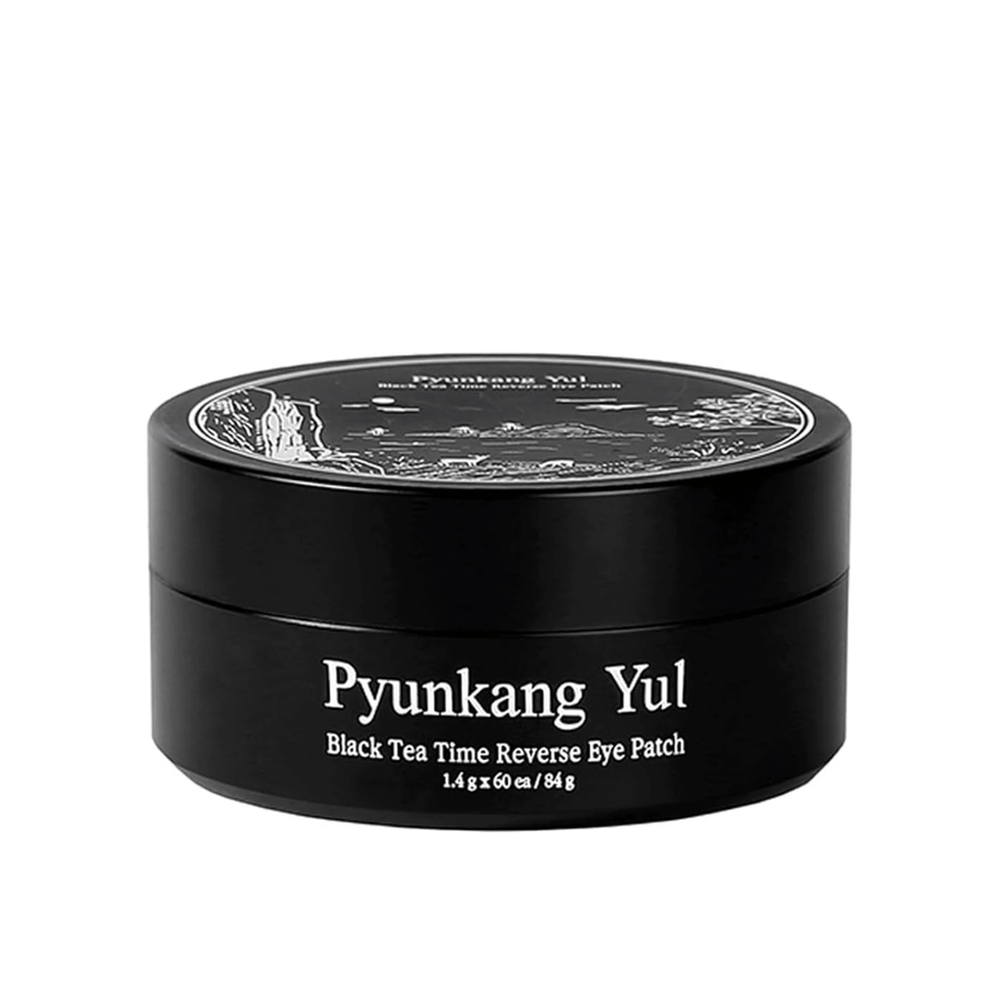 Cut-out product image of Pyunkang Yul Black Tea Time Reverse Eye Patch in black packaging with a sleek and minimalist design against a light background.