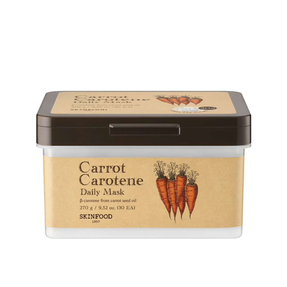 A package "Carrot Carotene Daily Mask" from SKINFOOD, containing 30 face masks. The product is enriched with β-carotene from carrot seed oil and is designed for daily use. The packaging is robust with a vintage-inspired label that highlights carrots as the main ingredient.