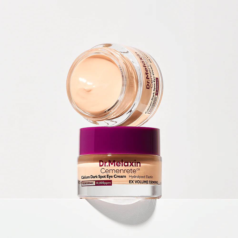 Dr.Melaxin Cemenrete Eye Cream balanced on jar lid, illustrating the cream's rich consistency and its focus on firmness and even skin tone around the eyes.