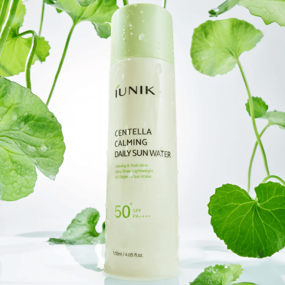 2. iUNIK Centella Calming Daily Sun Water SPF50+ PA++++ – moisturizing sunscreen with centella asiatica surrounded by green leaves and water droplets