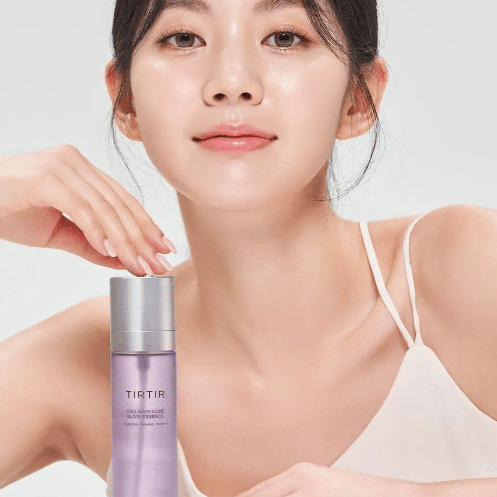 Woman with radiant skin posing with TIRTIR Collagen Core Glow Essence – a radiance-enhancing essence for firmer and moisturized skin.