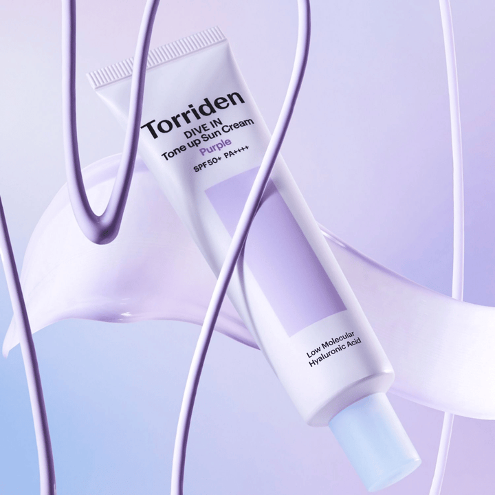 Torriden DIVE IN Tone Up Sun Cream Purple SPF50+ PA++++ presented in a creative product setting with purple details that highlight the moisturizing formula.