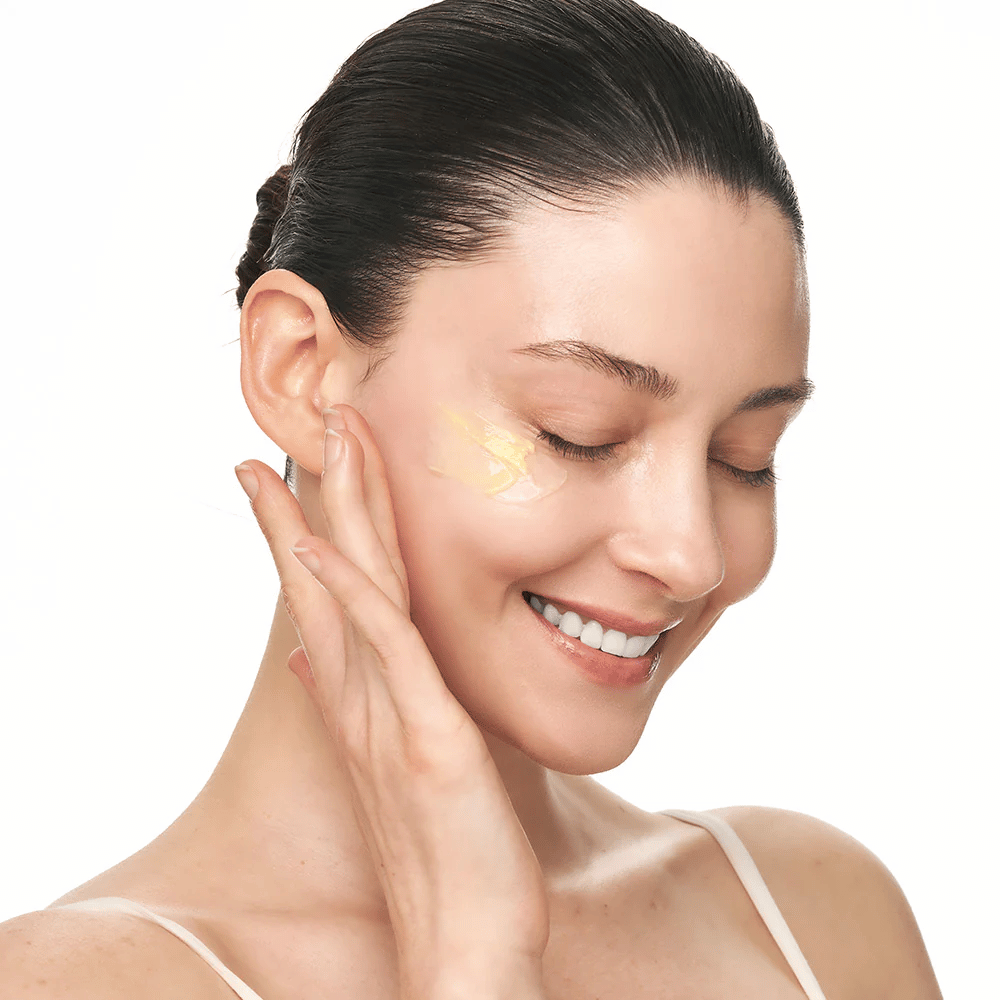 Person massages Sungboon Editor Deep Collagen Retinol Capsule Cream on the cheek. The product provides glow, firmness, and long-lasting hydration.