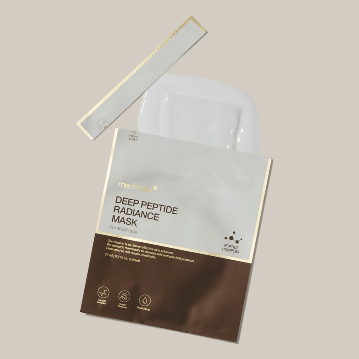 Medicube Deep Peptide Radiance Mask in opened packaging with visible Sheet mask, liquid presentation on neutral background.