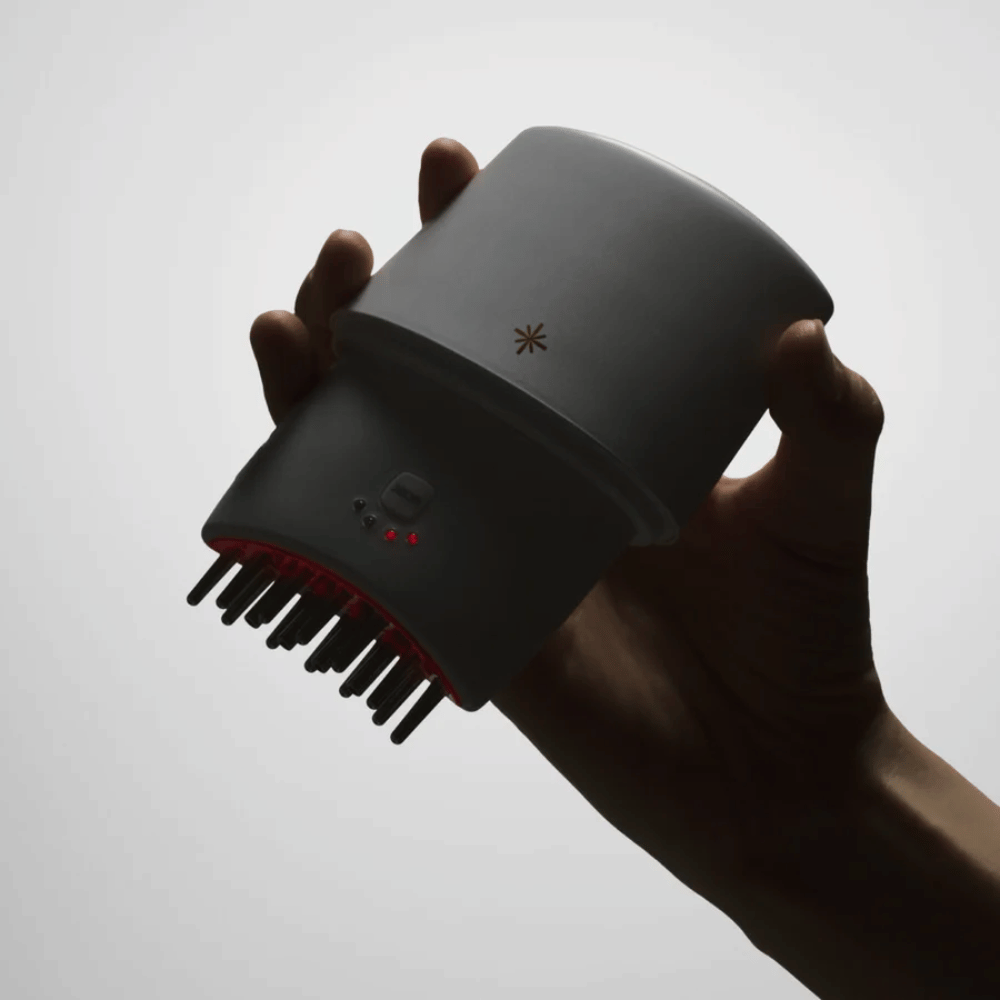 2. Lilyeve GrowTurn Pro – handheld scalp device with metal pins and red LED light