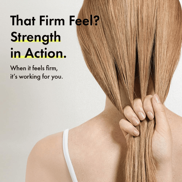 Person holding their hair to illustrate stronger hair strands and a firmer hair feel after using Grabity g0.0 Hair Lifting Shampoo Strong.