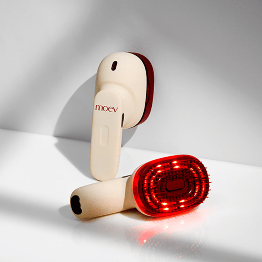 Two MOEV Hair Steamer Pro on a white background. One shows activated red LED lights that stimulate the scalp and improve hair growth.