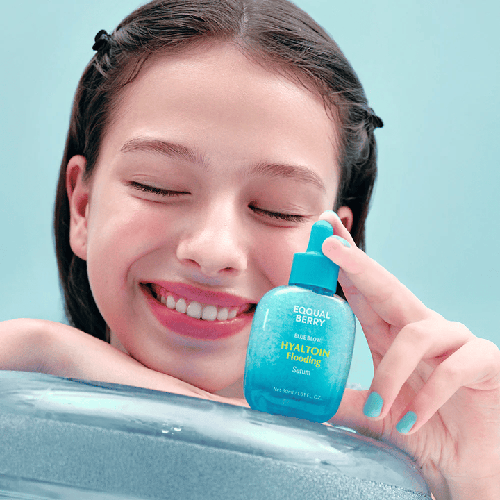 Model holds EQUAL BERRY Hyaltoin Flooding Serum – hydrating facial serum for soft and plumped skin