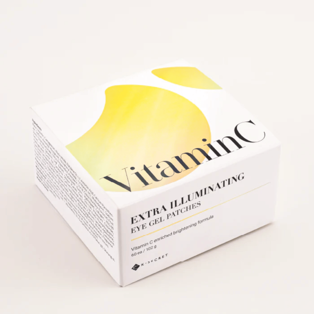 Packaging of K-Secret Extra Illuminating Eye Gel Patches with vitamin C in white and yellow design.