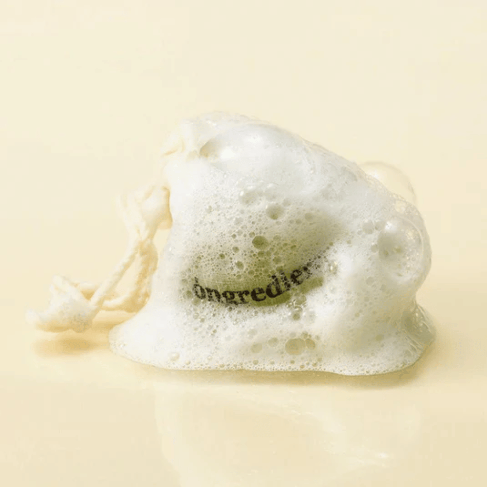Óngredients Jeju Green Tea Cleansing Ball in a net bag covered with soft foam – natural Korean facial soap.