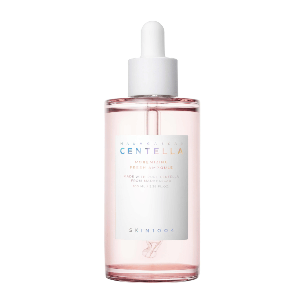 Transparent bottle with pink liquid and white dropper, SKIN1004 Madagascar Centella Poremizing Fresh Ampoule, against a white background.