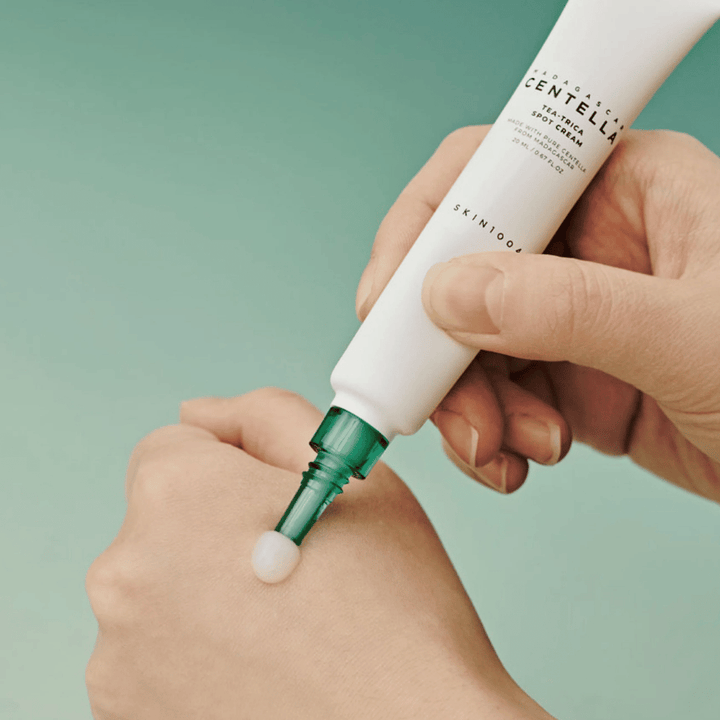 Application of SKIN1004 Madagascar Centella Tea-Trica Spot Cream on the skin – targeted treatment for pimples, blemishes, and inflamed areas.