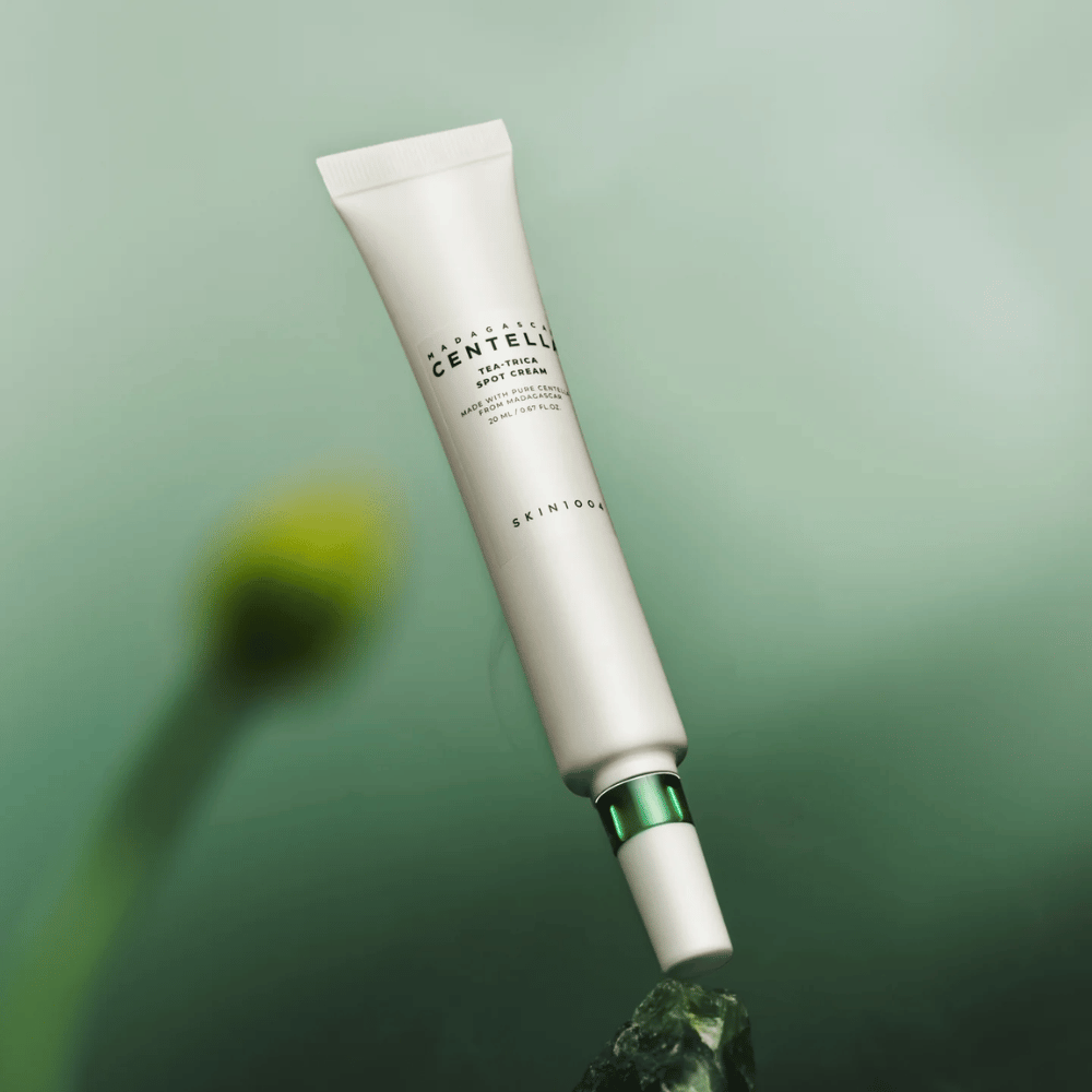 SKIN1004 Madagascar Centella Tea-Trica Spot Cream floating against a green background – effective spot treatment for acne-prone skin with centella from Madagascar.
