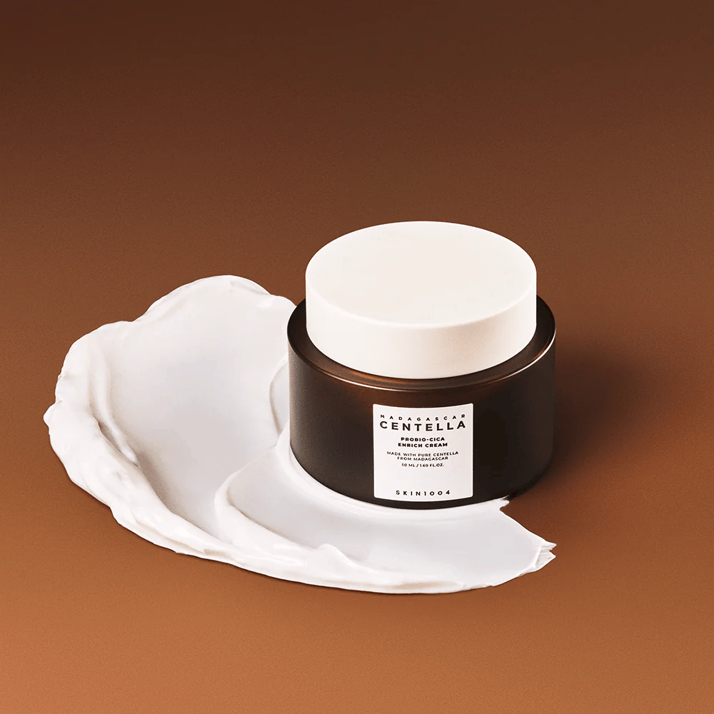 SKIN1004 Madagascar Centella Probio-Cica Enrich Cream placed on a layer of cream – moisturizing and soothing face cream with centella asiatica.