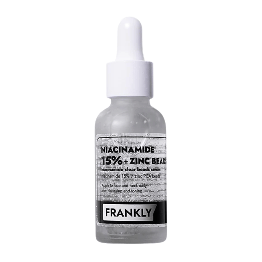 Product image of FRANKLY Niacinamide 15% + Zinc Beads Serum in a glass bottle with a pipette. A serum that balances, soothes, and improves skin clarity.