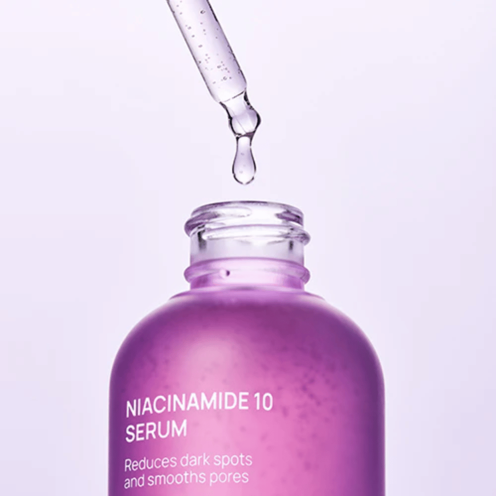 Close-up of bottle and pipette with Jumiso Niacinamide 10 Serum. Transparent drop of light formula that is quickly absorbed into the skin.