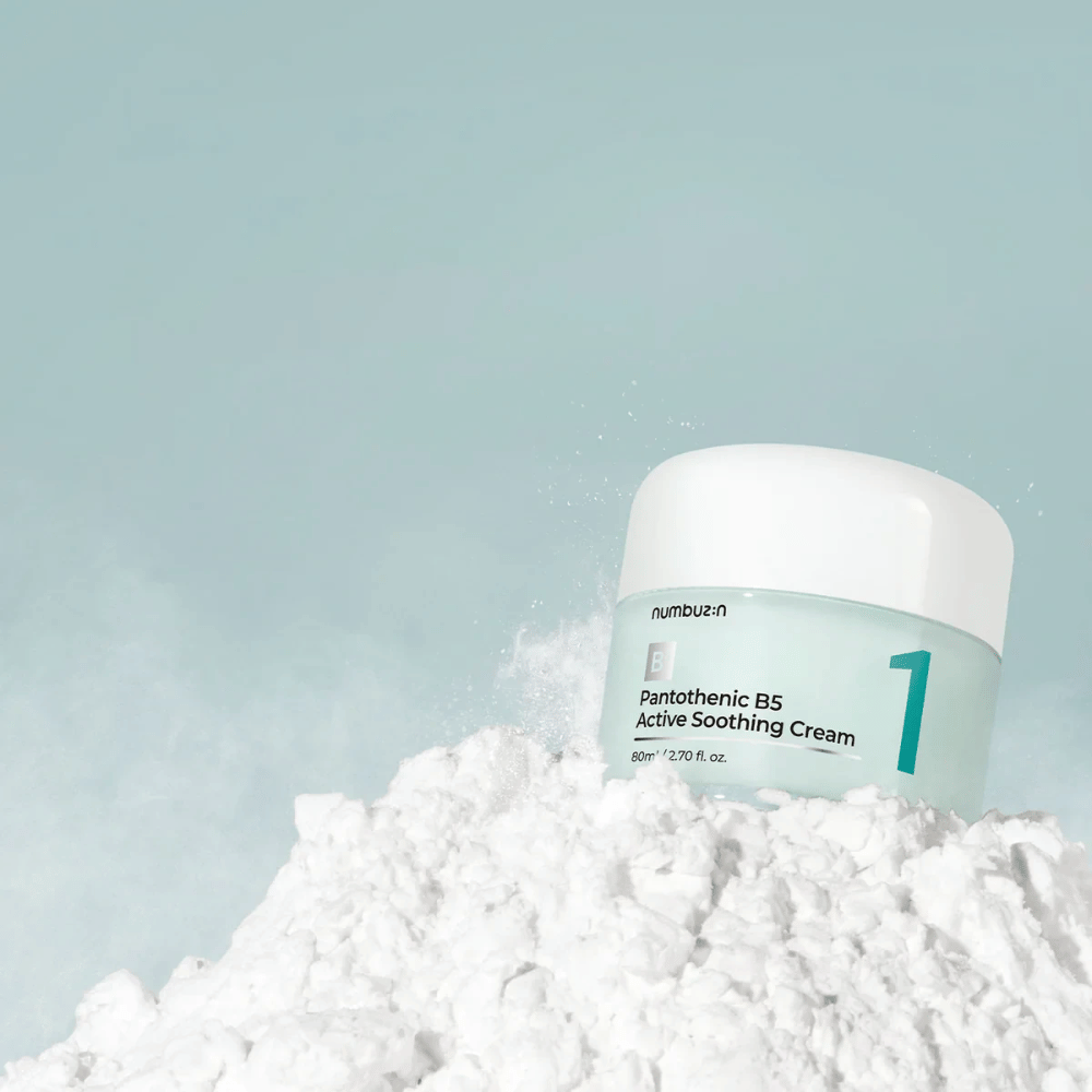 Numbuzin No.1 Pantothenic B5 Active Soothing Cream 80 ml in a light green jar with a white lid, placed on a pile of white powder against a light background.