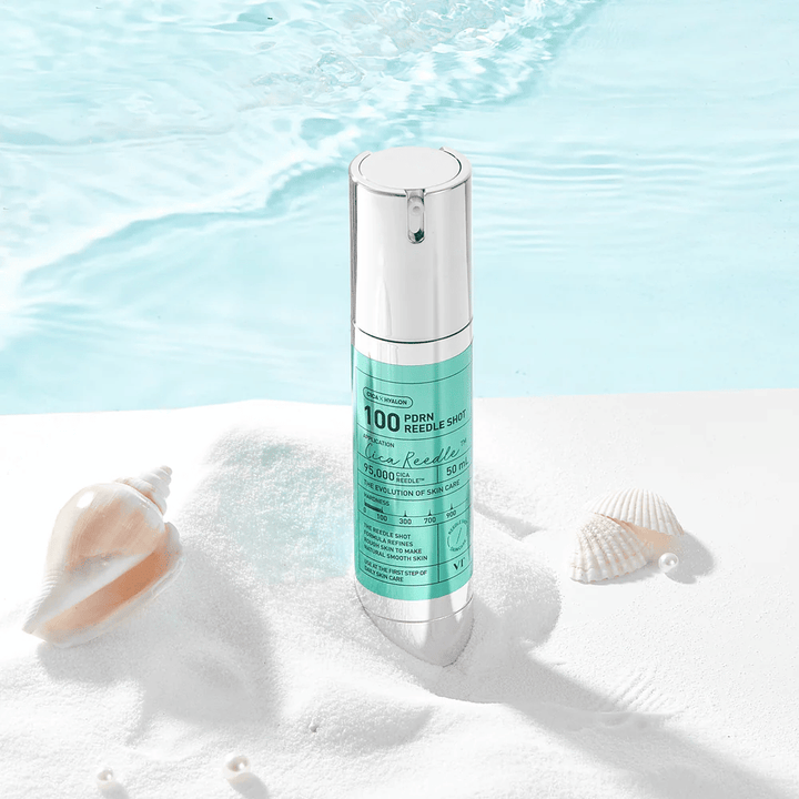 VT Cosmetics PDRN Reedle Shot 100 product placed in a sandy environment with an ocean theme that symbolizes hydration, a soothing effect, and skin improvement