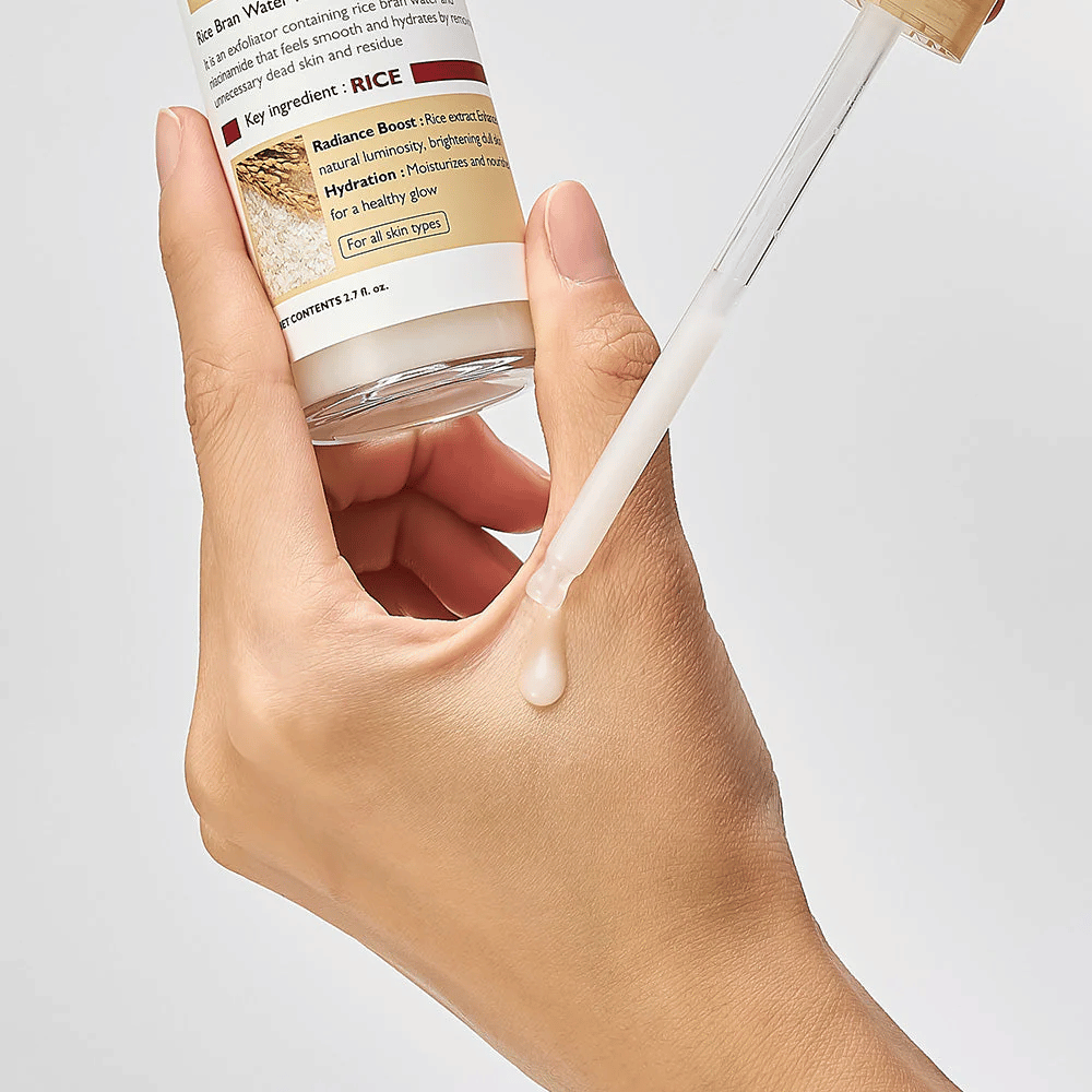 Close-up of Dr.Melaxin Peel Shot Rice Ampoule applied with a pipette on hand, lightweight exfoliating ampoule that absorbs quickly and provides hydrated, smooth skin.
