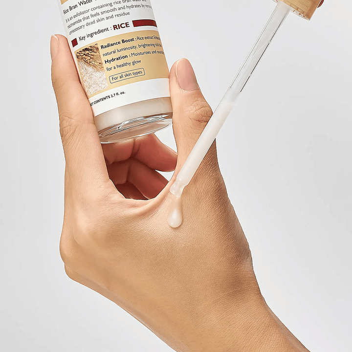 Close-up of Dr.Melaxin Peel Shot Rice Ampoule applied with a pipette on hand, lightweight exfoliating ampoule that absorbs quickly and provides hydrated, smooth skin.