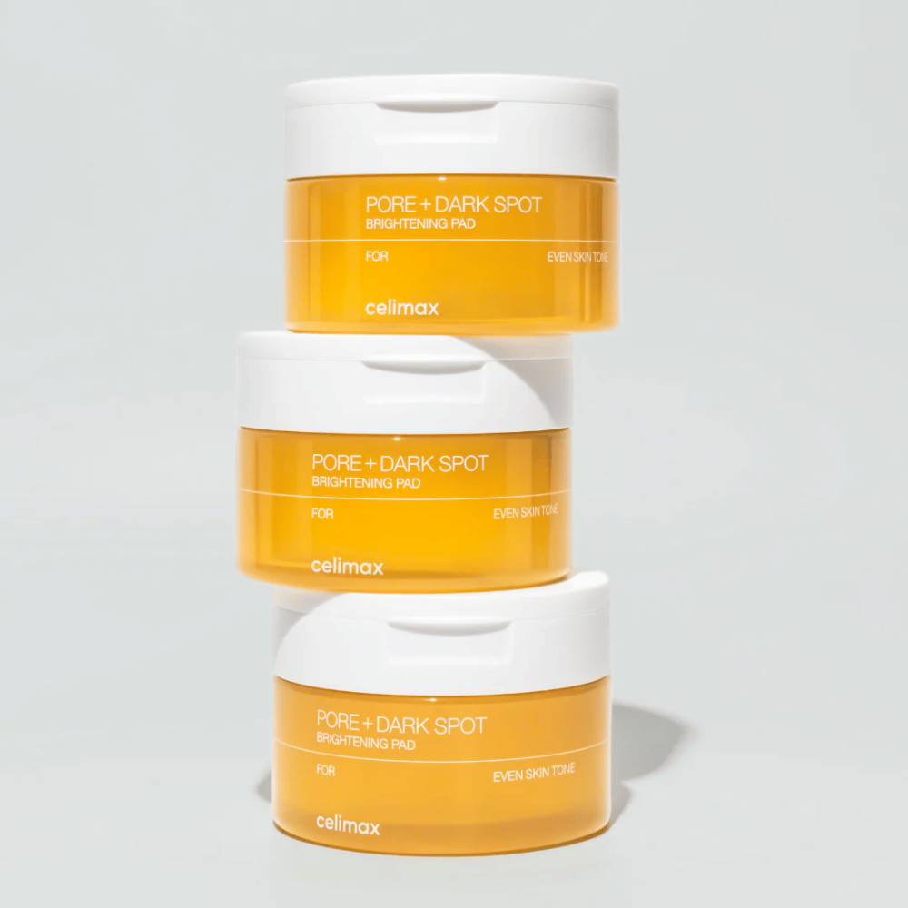 Three jars of Celimax Pore + Dark Spot Brightening Pad – illuminating exfoliating pads for smoother skin and clearer radiance.