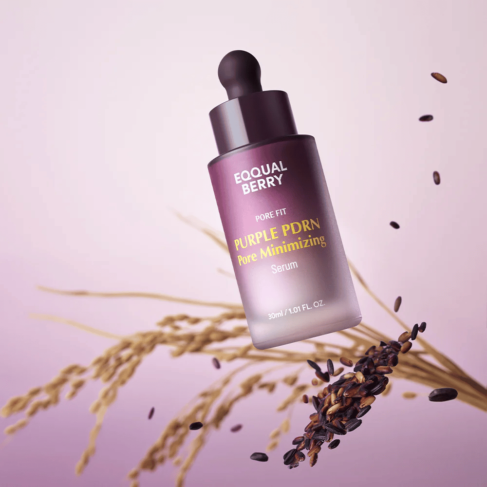 Bottle with Equal Berry Purple PDRN Pore Minimizing Serum floats against a purple background, surrounded by black rice grains and rice straws.