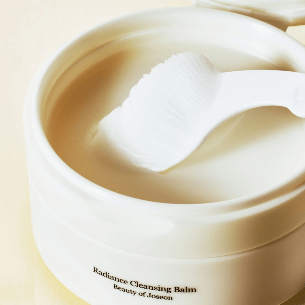Close-up of Beauty of Joseon Radiance Cleansing Balm in a jar with the spatula – silky balm that cleanses and moisturizes.