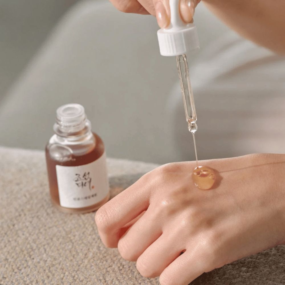 Pipett droppar Beauty of Joseon Revive Serum Ginseng + Snail Mucin på huden – koreanskt serum för elasticitet och återfuktning.