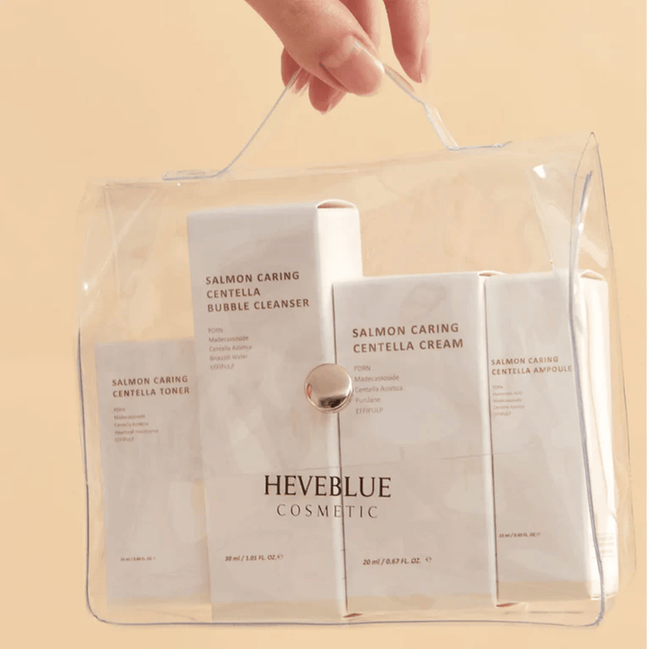 Heveblue Salmon Caring Centella Special Travel Kit toiletry bag – complete Korean skincare set with toner, cleanser, cream, and ampoule in a transparent travel bag.