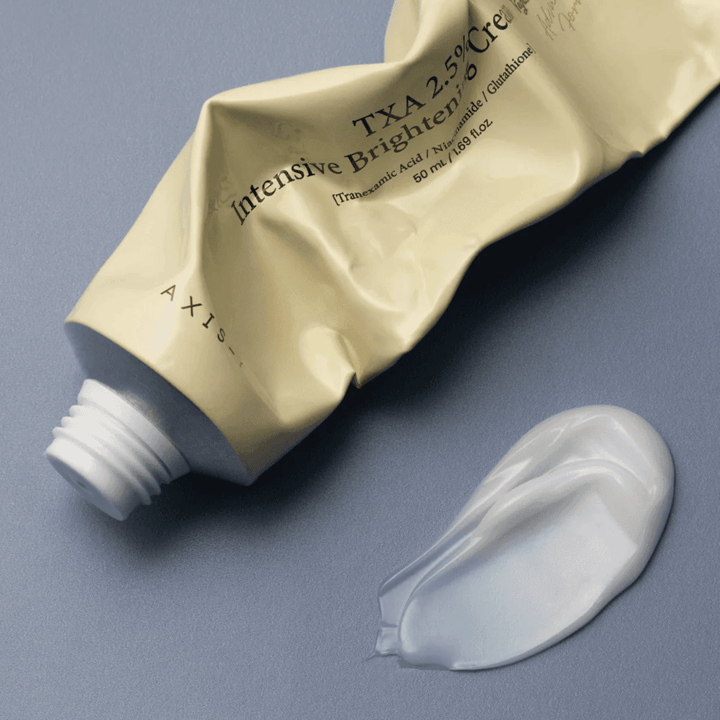 Product image with the tube and a dollop of cream beside it to show the soft, creamy texture and hydrating formula. The focus is on glow and even application.