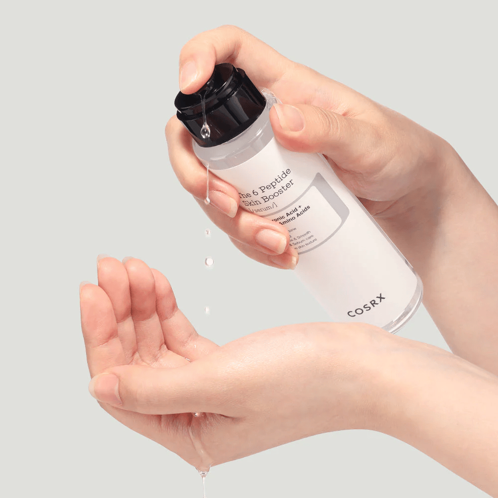 Hands pouring out skincare product from a transparent bottle with the text "The Peptide Skin Booster".