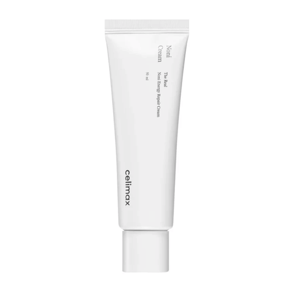 Celimax Noni Energy Repair Cream in a white tube with black text. The product is labeled as "The Real Noni Energy Repair Cream" and has a volume of 50 ml.