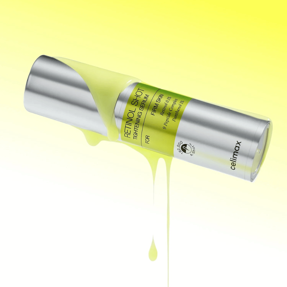 Product image of The Vita-A Retinol Shot Tightening Serum from Celimax with yellow serum running down the bottle against a light yellow background.
