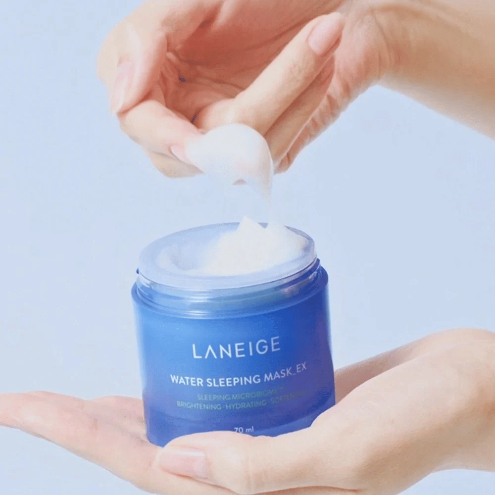 A hand scoops up LANEIGE Water Sleeping Mask from a blue jar, focusing on the gel-like texture against a light blue background.