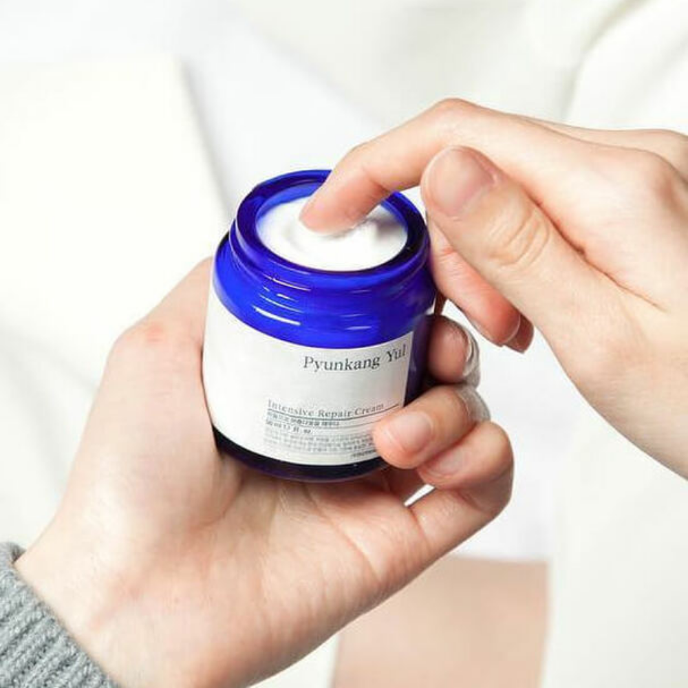 A person is holding a jar Pyunkang Yul Intensive Repair Cream 50ml.